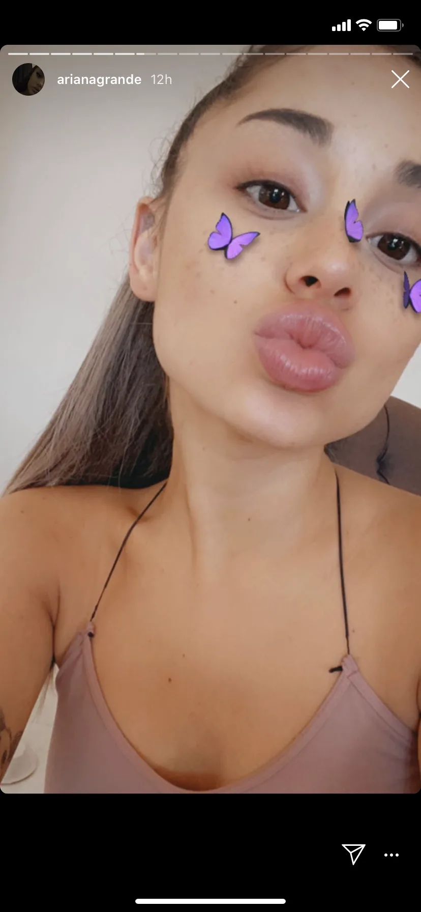 Ari embracing her natural beauty and referencing her butterfly tattoos.