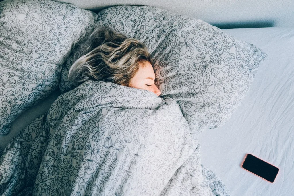 girl-asleep-beside-phone