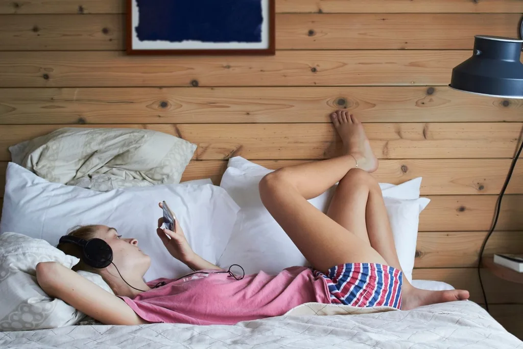 girl-watching-phone-headphones