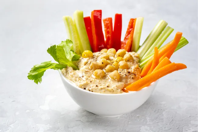 Veggie sticks including carrot, celery and capsicum with hummus
