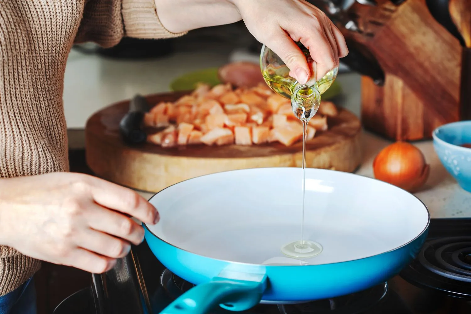 person pouring cooking oil on a pan