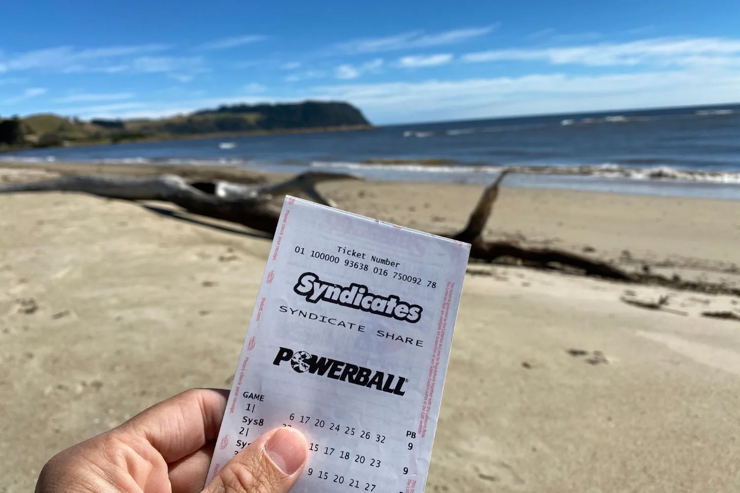 A person holds a Powerball Syndicates ticket