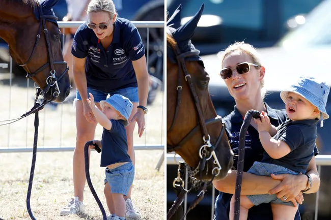 Woman and toddler interact with a horse; the woman holds the child, wearing a sun hat, at an outdoor event.