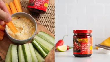 Carrot dipped in spicy mayo near cucumber; Lee Kum Kee Chili Oil jar and chili peppers on white background.