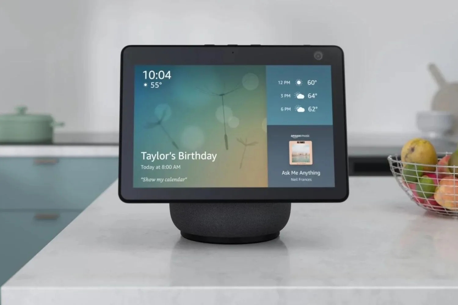 amazon echo show 10 screen displaying time, weather, a reminder reading "taylor's birthday" and a book cover