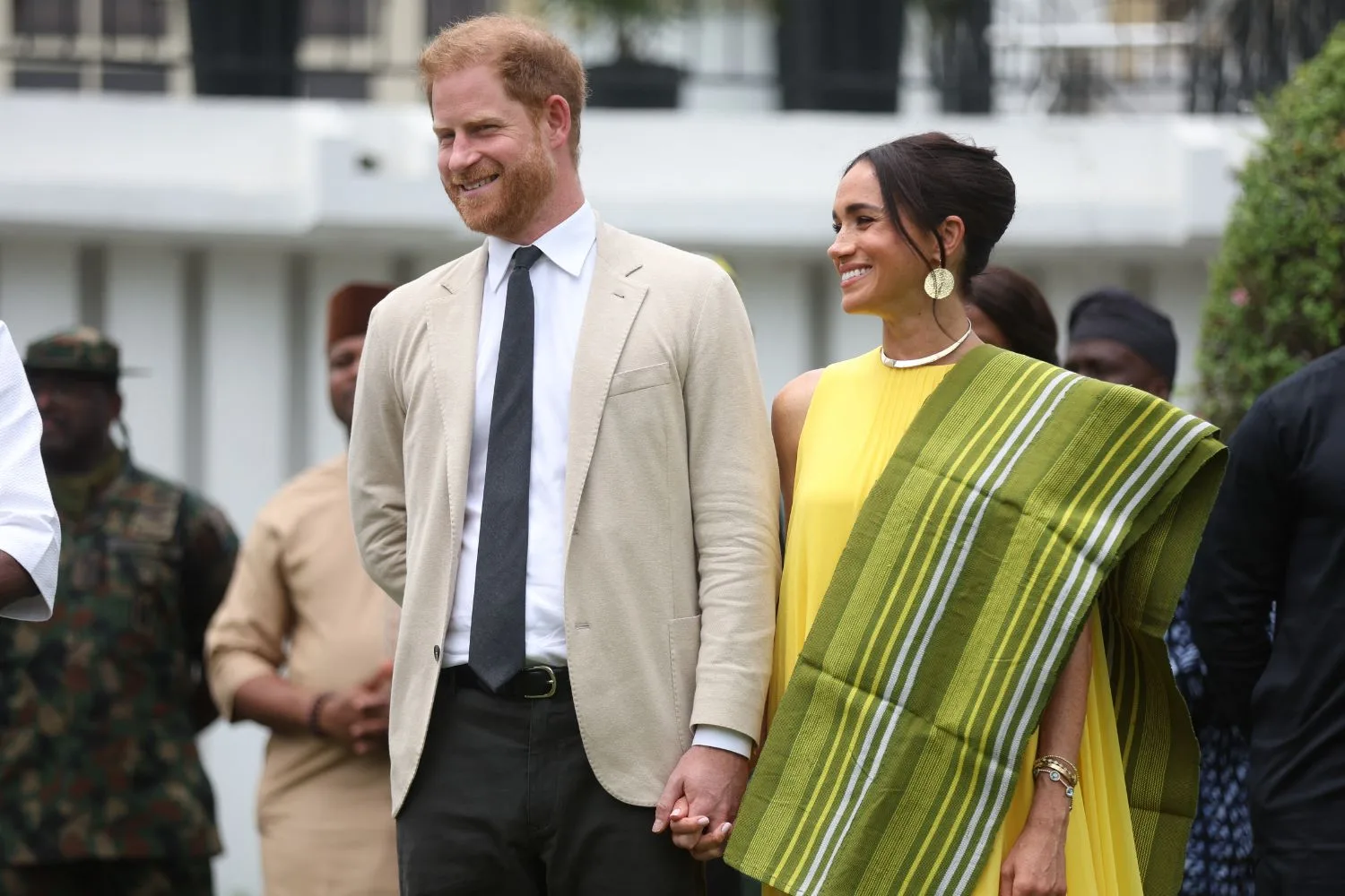 prince harry and meghan markle standing hand in hand as they visit nigeria as part of celebrations of invictus games anniversary