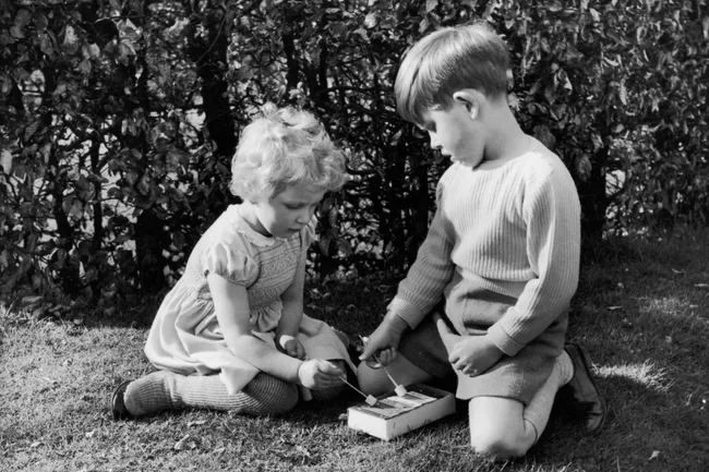 princess anne and king charles play on the grass
