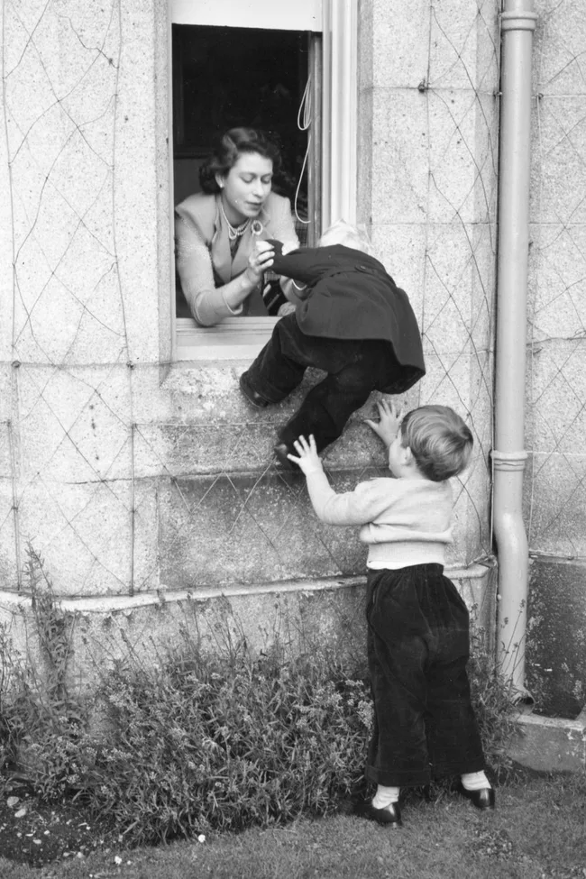 king charles helps princess anne into a window