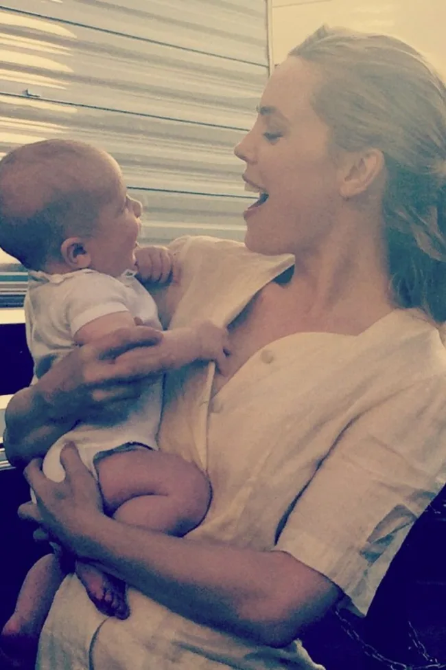 melissa george holding her baby while on set