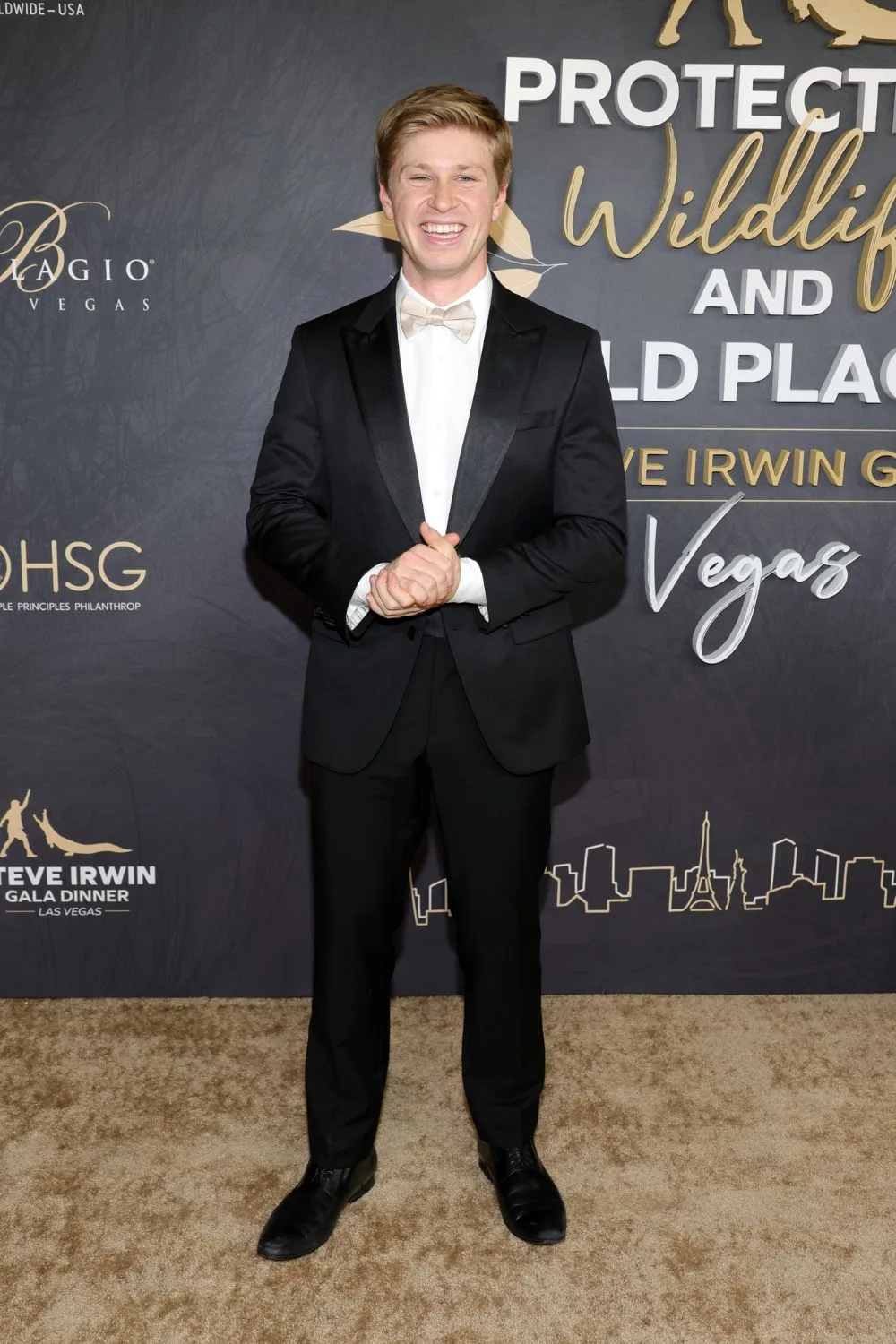 robert irwin poses with big smile at the steve irwin gala dress in a suit and bowtie