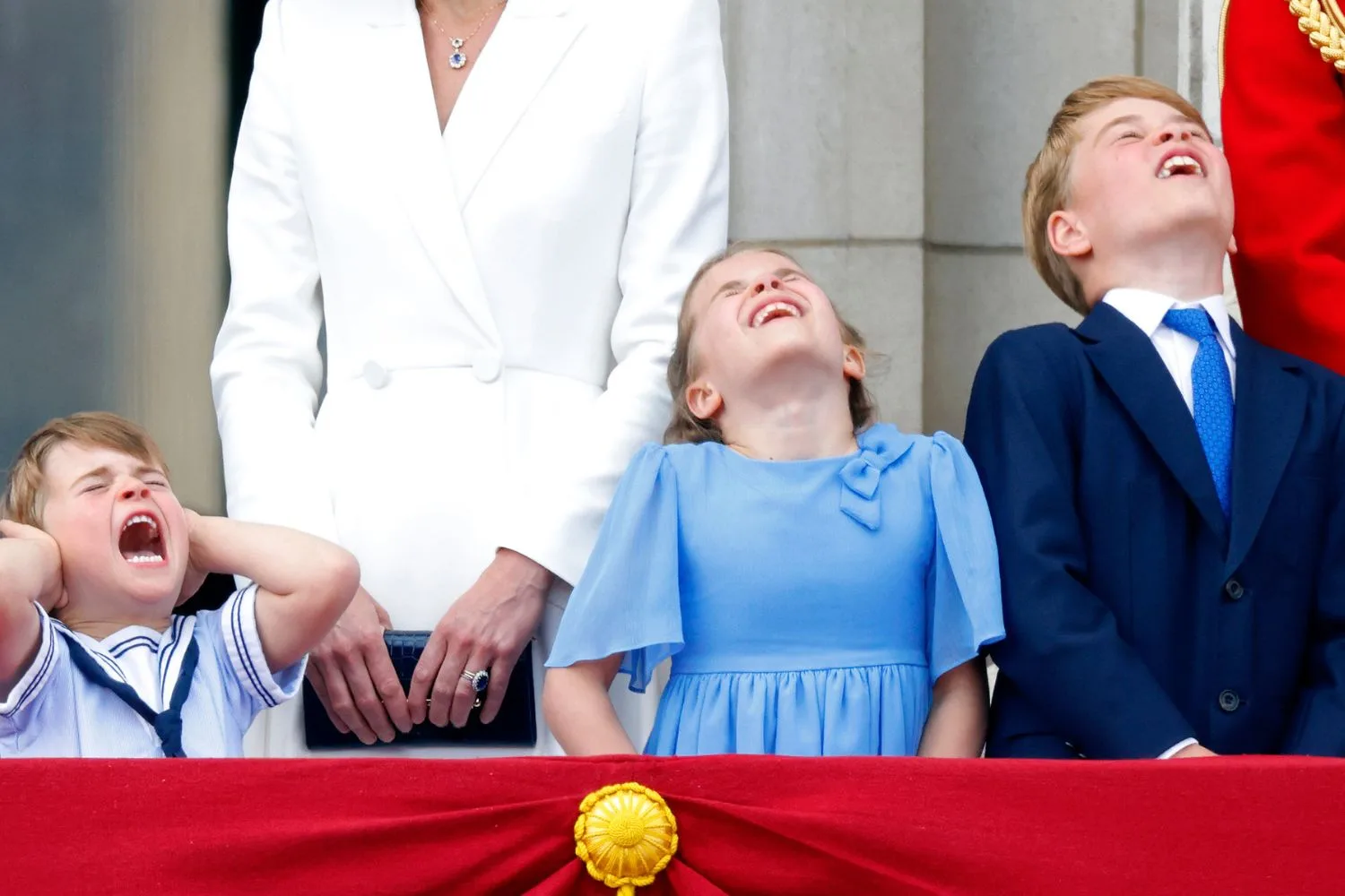 prince louis, princess charlotte and prince george on the balcony at buckingham palace, all pulling the same face