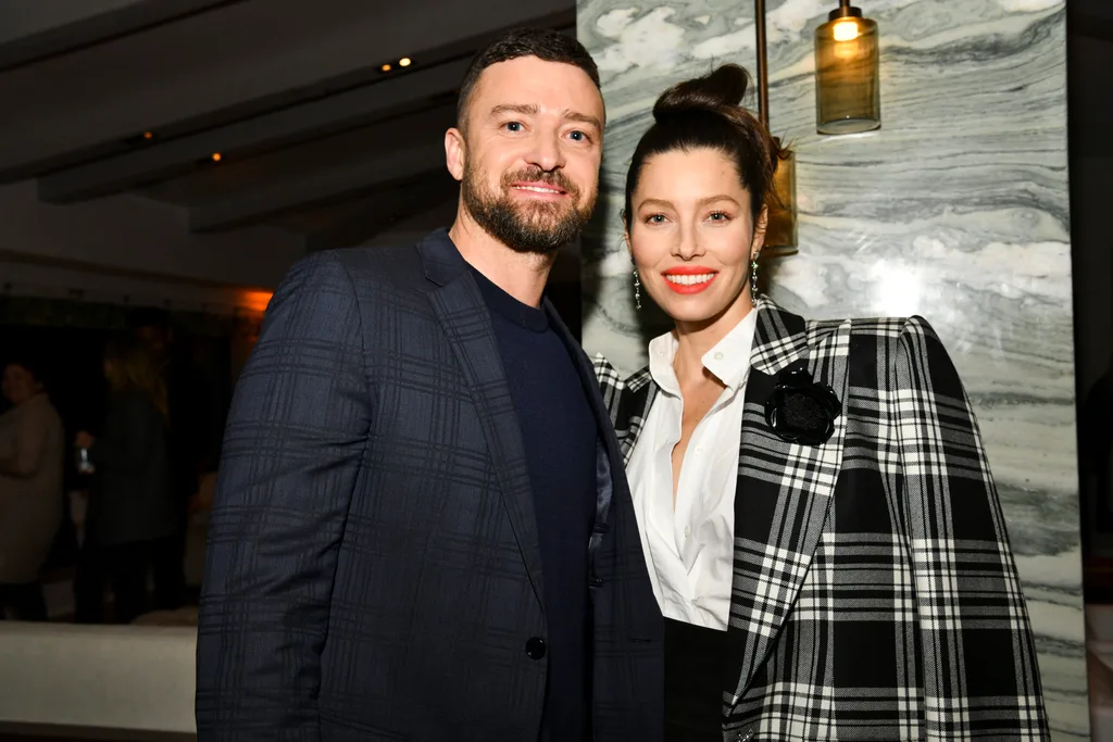Justin Timberlake and Jessica Biel dressed in formal attire, standing close together in an indoor setting.