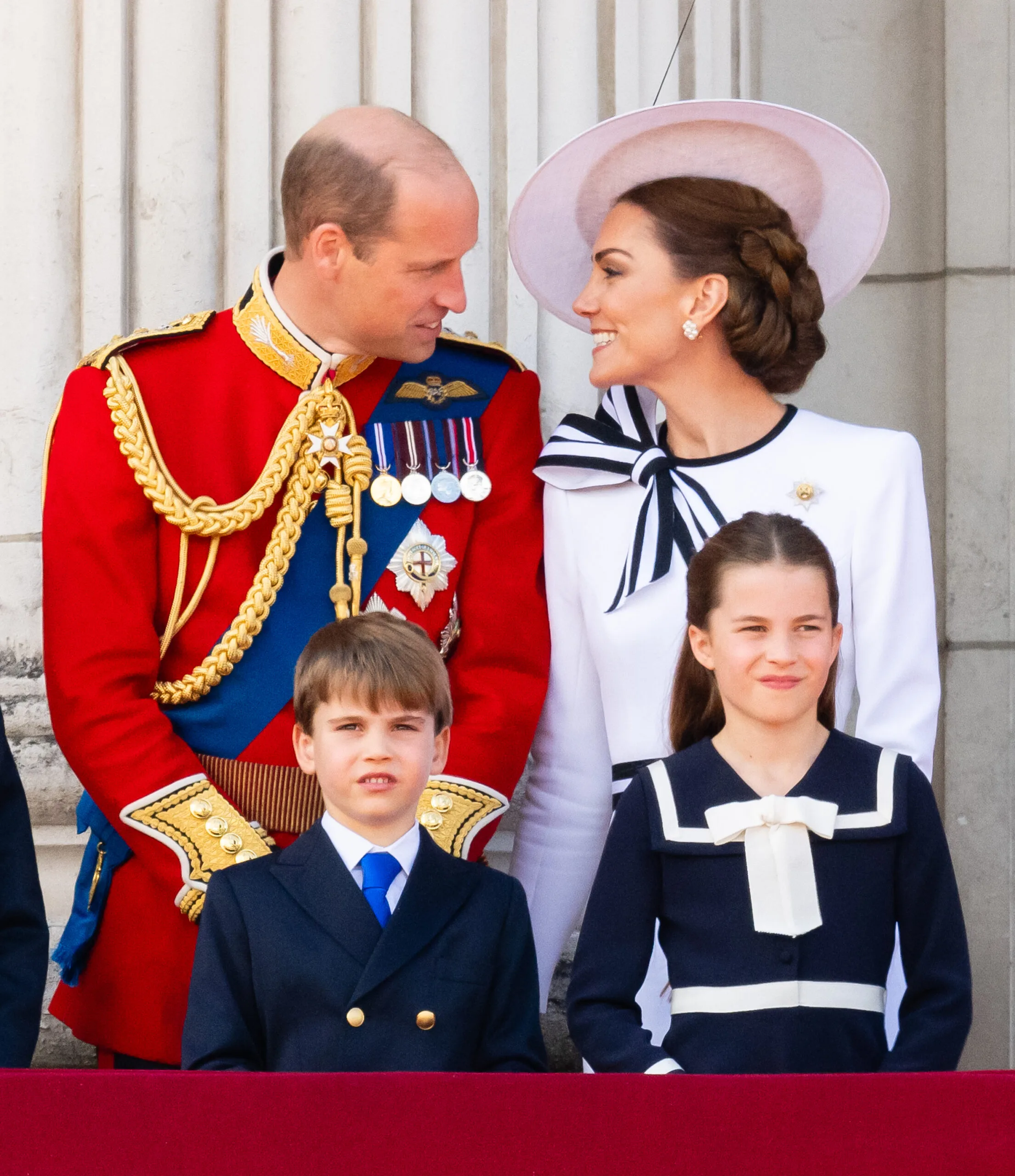 LONDON, ENGLAND - JUNE 15: Prince William, Prince of Wales, Prince Louis of Wales, Princess Charlotte of Wales and Catherine, Princess of Wales during Trooping the Colour on June 15, 2024 in London, England. Trooping the Colour is a ceremonial parade celebrating the official birthday of the British Monarch. The event features over 1,400 soldiers and officers, accompanied by 200 horses. More than 400 musicians from ten different bands and Corps of Drums march and perform in perfect harmony. (Photo by Samir Hussein/WireImage)