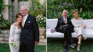 An elderly couple in formal attire, posing in a garden setting. They appear to be attending a special occasion.