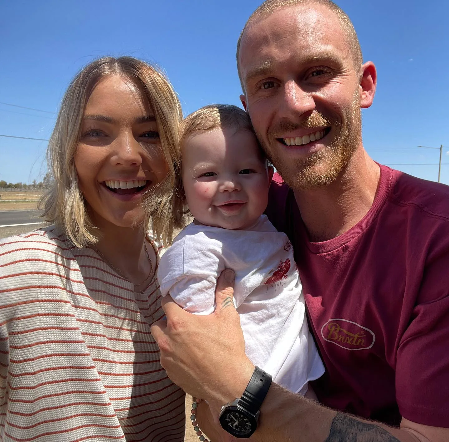sam frost, jordie hansen, and their son theodore pose for a photo outside