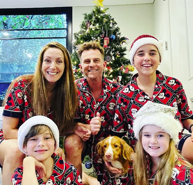 david and lisa campbell pose with their three children in matching christmas pyjamas