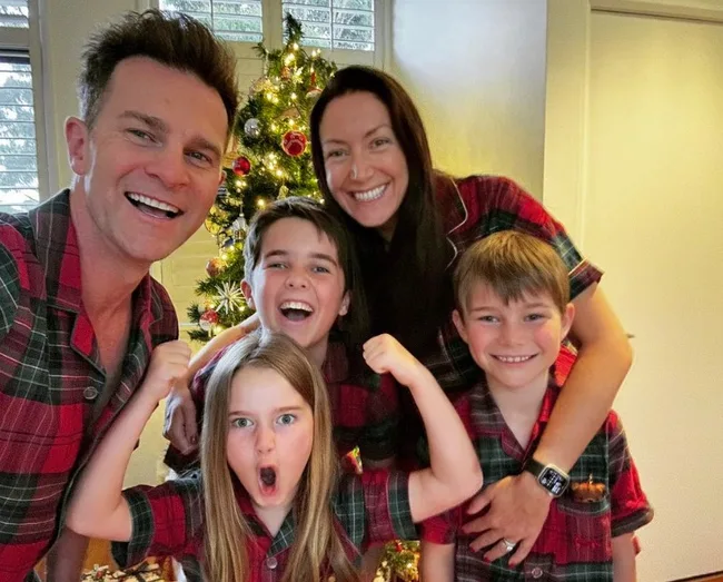 david and lisa campbell with their three kids dressed in matching christmas pyjamas