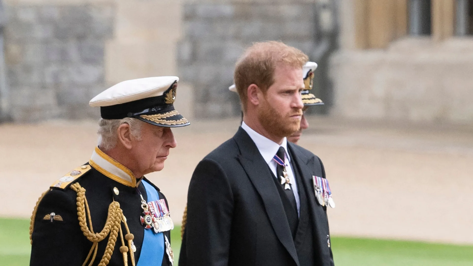 King Charles and Prince Harry stand side by side at a function at Buckingham Palace, London