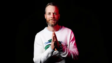 hamish blake grey jumper black background