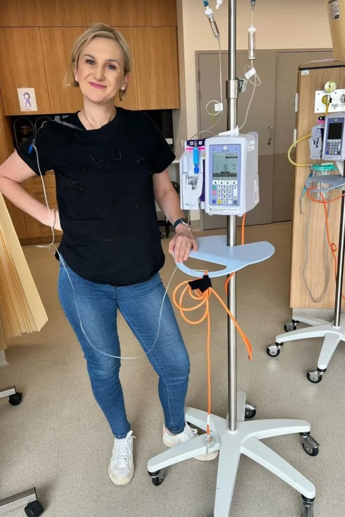 gemma Farquhar standing next to a machine in a hospital