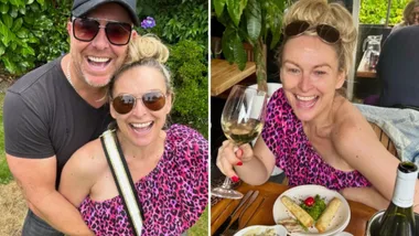 A woman in a pink leopard print top smiling with a man in sunglasses outdoors, and holding a wine glass at a restaurant.