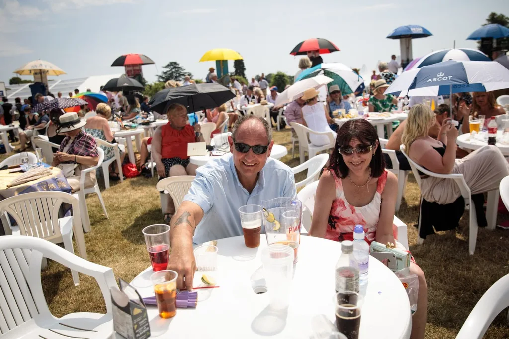 Racegoers sit in the Windsor Enclosure at Royal Ascot
