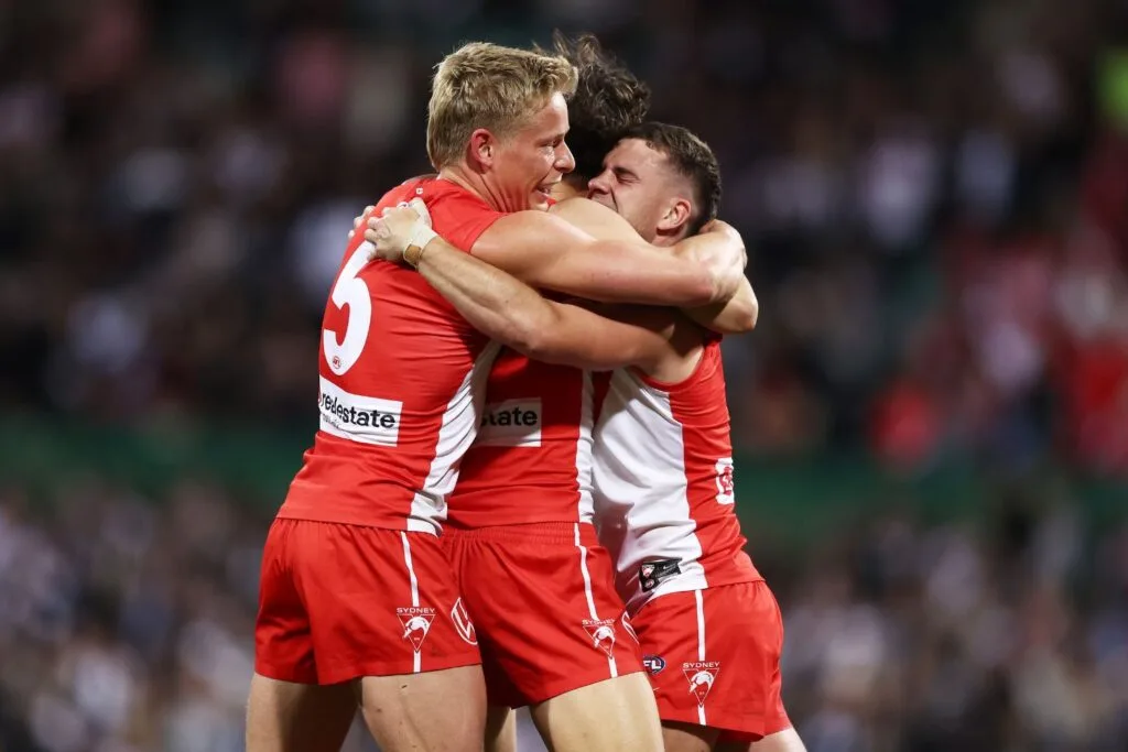 sydney swans team members hugging