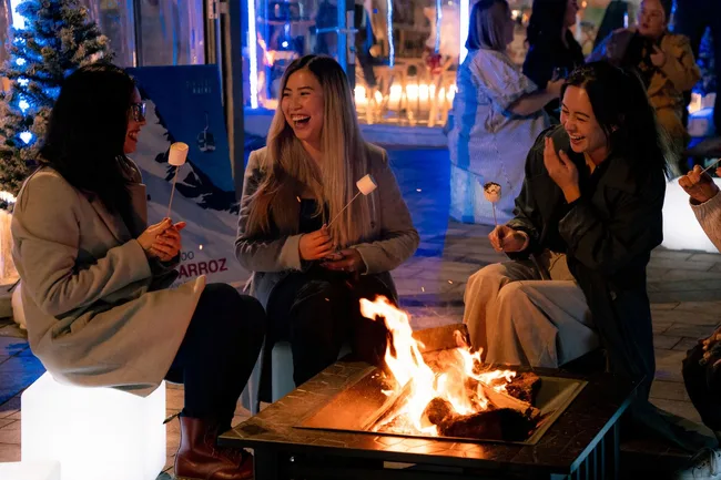 worldsquare firepit garden girls roasting marshmallows over a fire