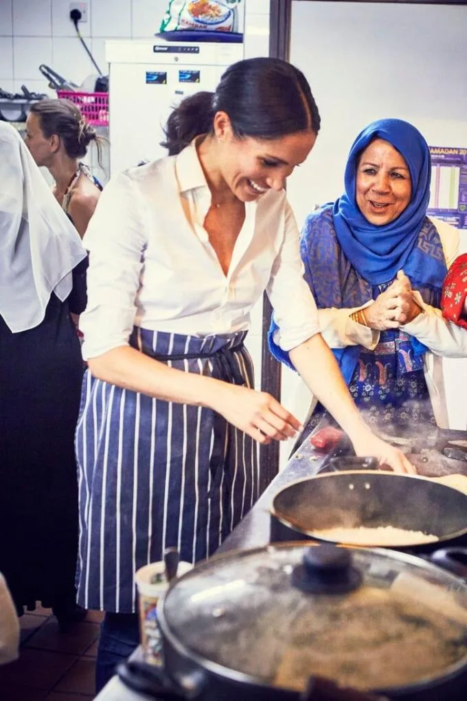 Meghan Markle in kitchen with a pot cooking