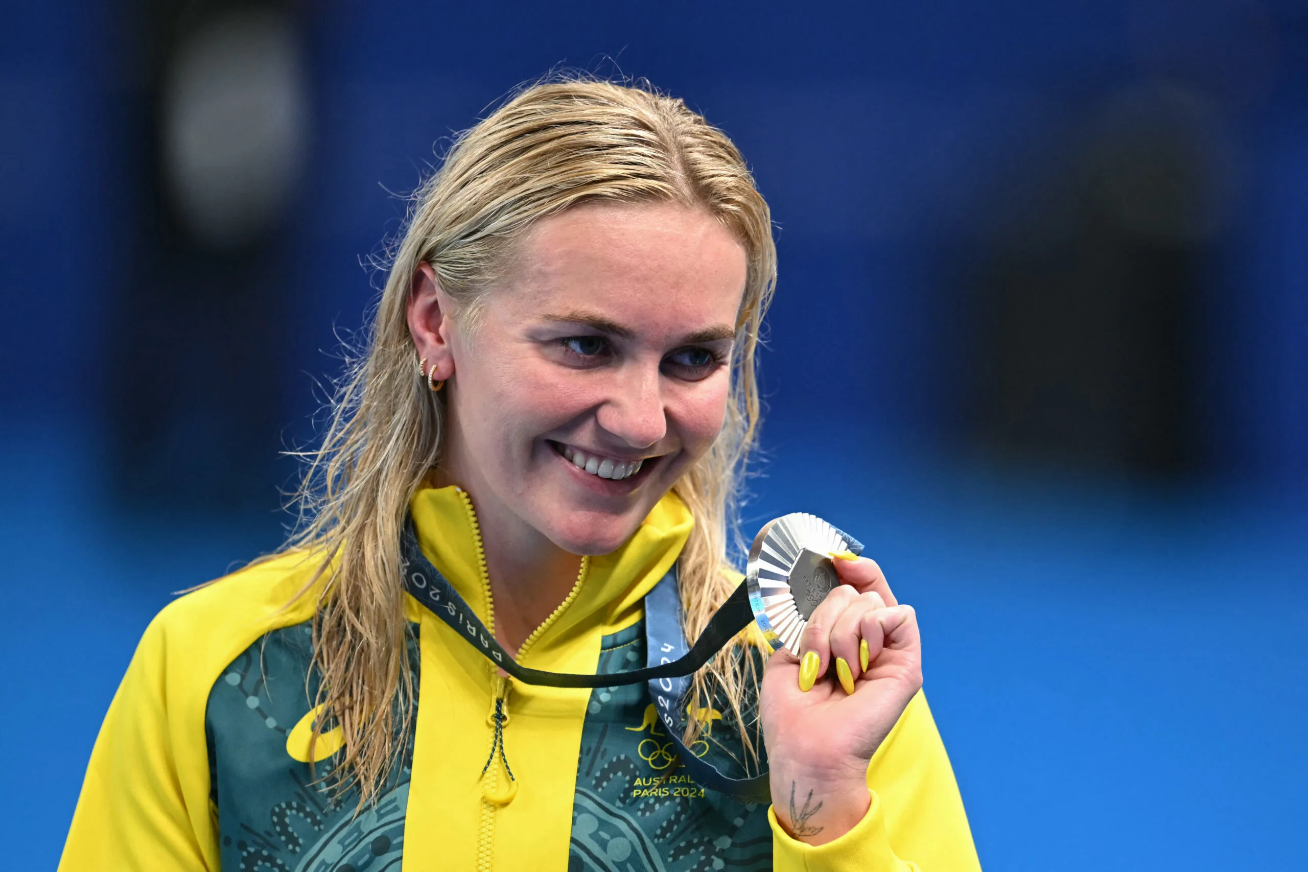 Ariarne Titmus poses with her medal on the podium of the women's 200m freestyle swimming event