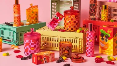 Colorful display of Allen's candy packaging and jars on stacked crates with various candy pieces scattered around.