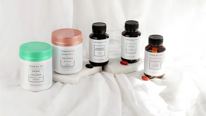 Jars of JSHealth supplements on a light background, including collagen, magnesium, and detox products.
