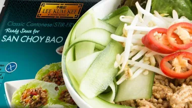 Bowl with San Choy Bao ingredients beside Lee Kum Kee sauce packet.