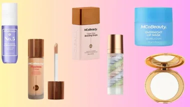 MCoBeauty cosmetics including mist, foundation, bronzing drops, lip mask, serum, and compact on a gradient background.