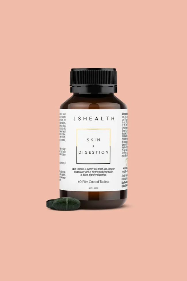 JSHealth Skin + Digestion tablets bottle on a peach background.