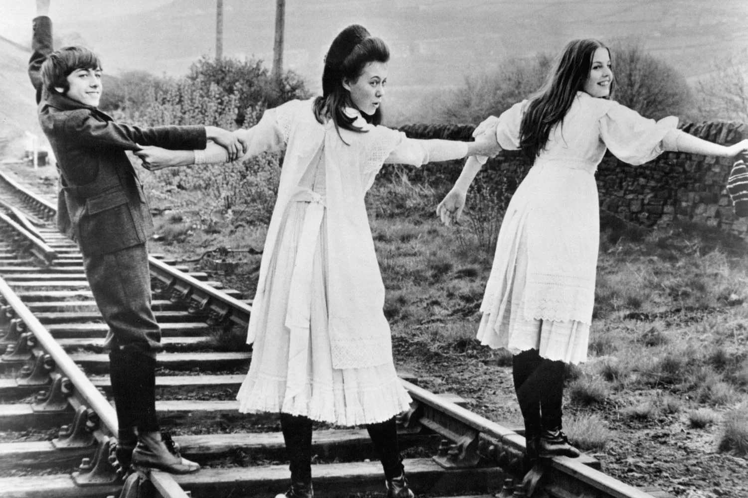 Gary Warren, Jenny Agutter and Sally Thomsett cross a railroad in a scene from the film 'The Railway Children', 1970.