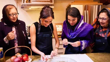 Meghan Markle cooking in kitchen