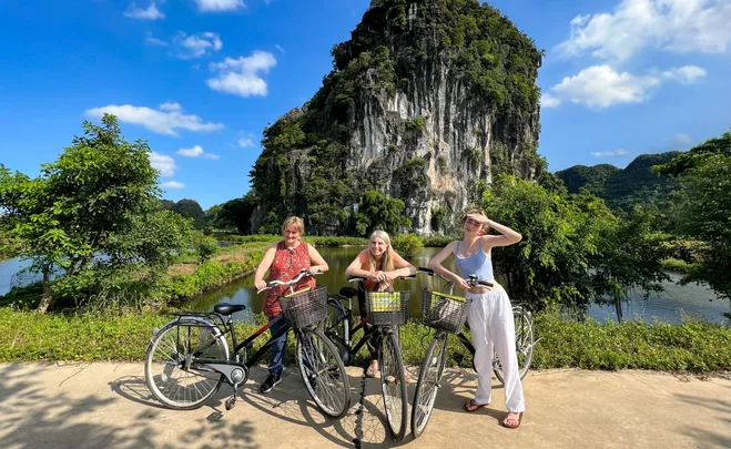 group of three female travellers on bikes in vietname