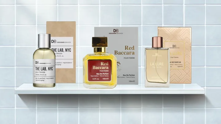 Three perfume bottles on a shelf: The Lab, NYC; Red Baccara; and La Lure by Designer Brands against a tiled background.
