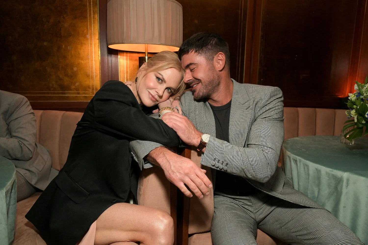 nicole kidman and zac efron cuddling on a couch