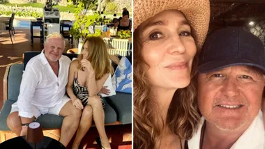Couple sitting together in a sunny outdoor setting and taking a selfie with a hat and cap.