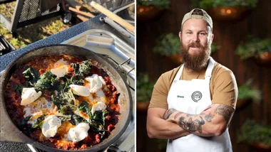 Cast iron pan with shakshuka and a man with a beard and tattoos wearing an apron with crossed arms.