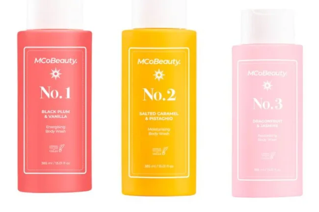 Three MCoBeauty body wash bottles: No. 1 (plum), No. 2 (caramel), No. 3 (dragonfruit).