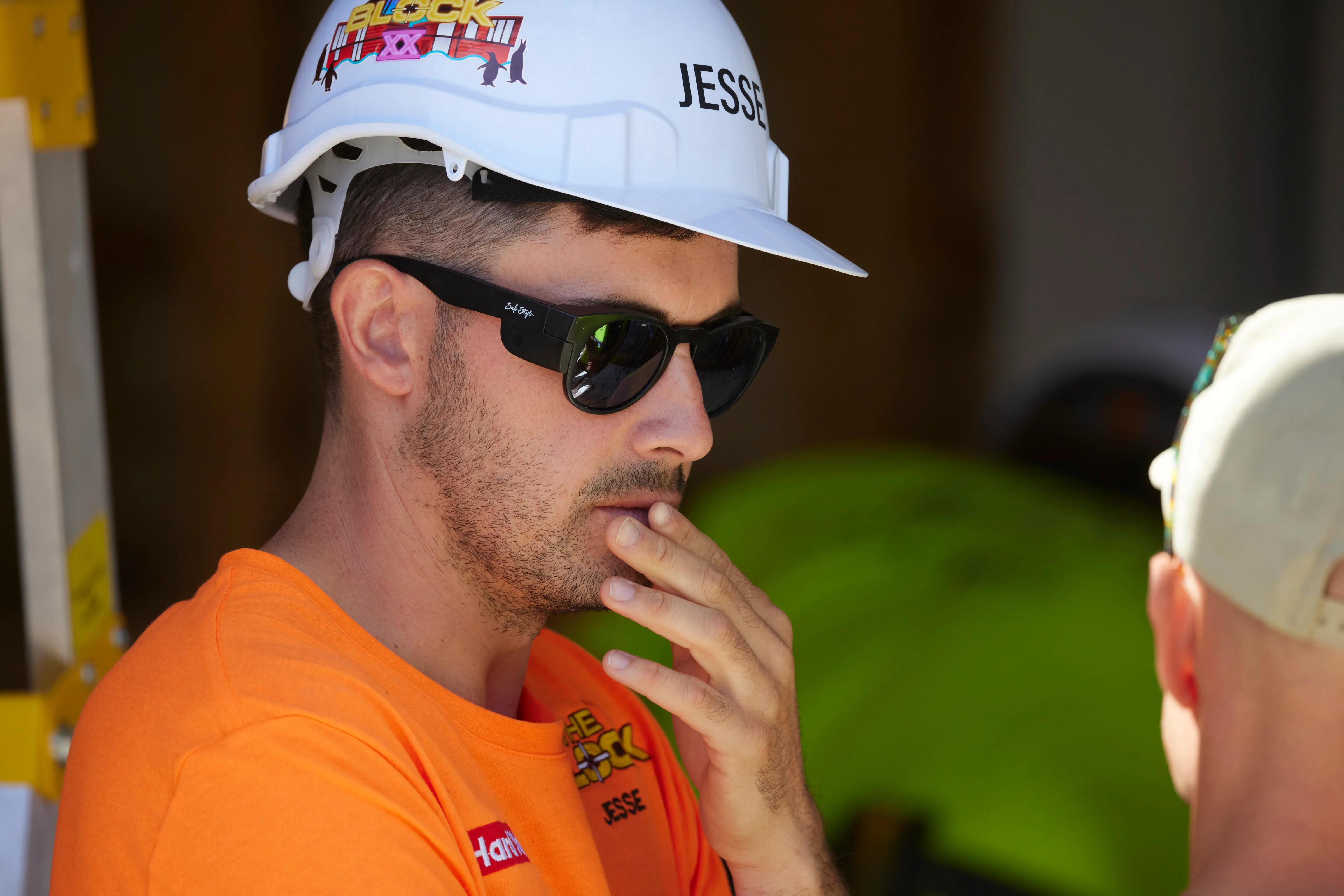the block's jesse wearing a helmet and sunglasses on set