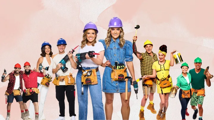 Group of nine people in colorful work outfits and helmets holding tools against a pastel background.