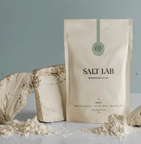 Salt Lab Magnesium Bath Salts pouch on display with clay blocks and powder around it.