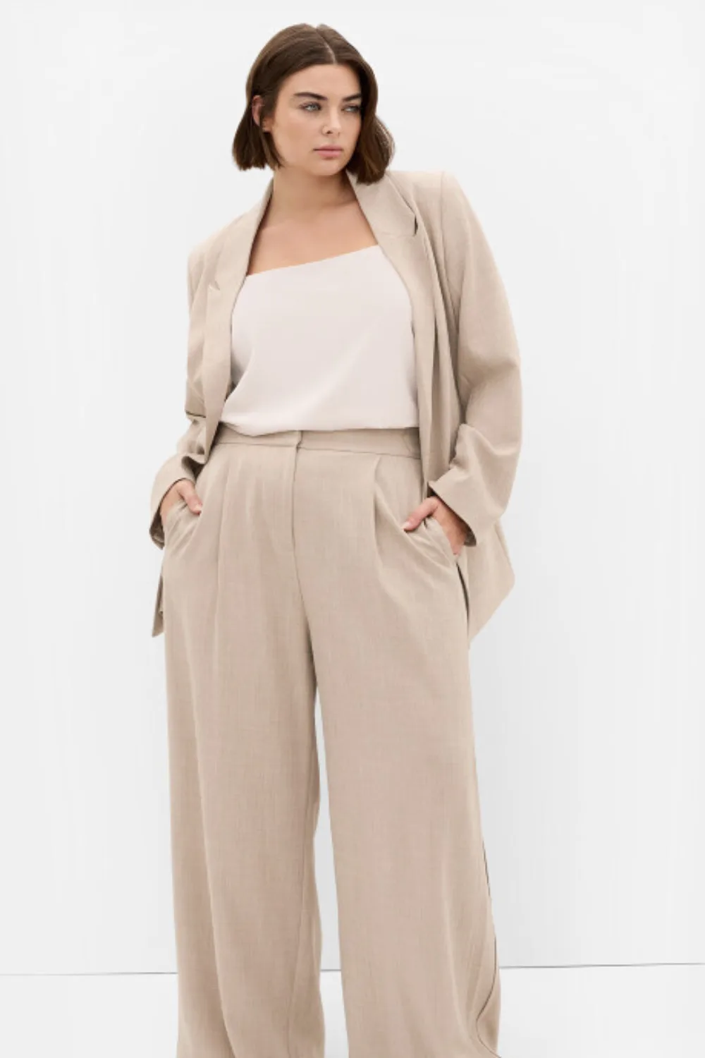 city chic model wearing beige blazer and pant suit