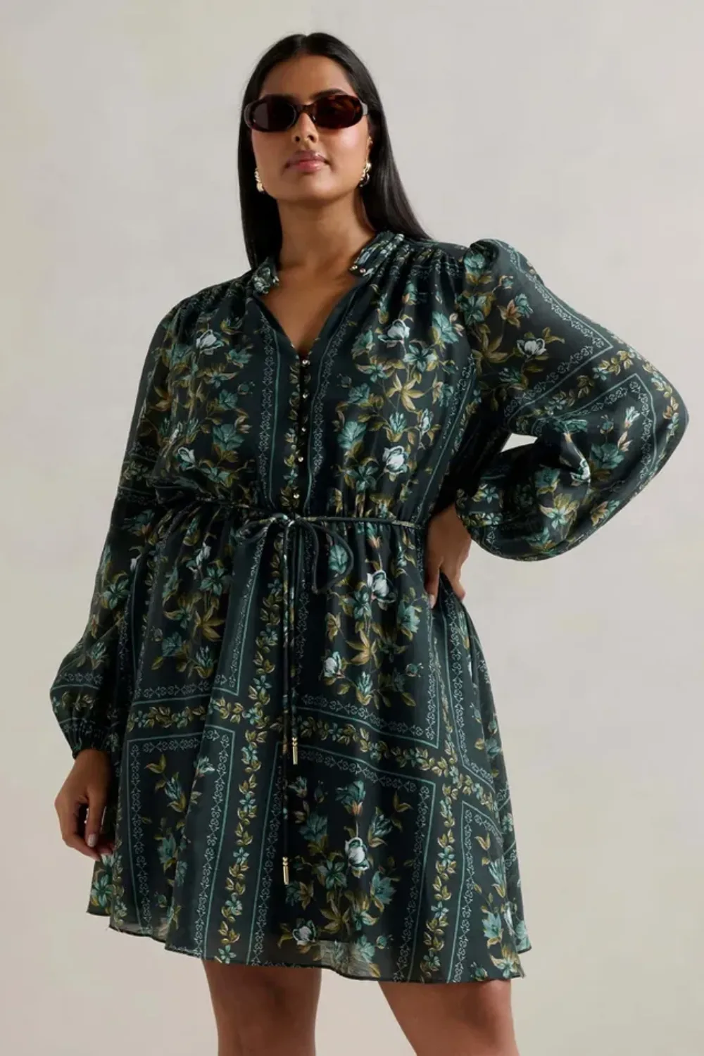 Forever new model wearing green patterned long sleeve dress and sunglasses best plus size clothing brands