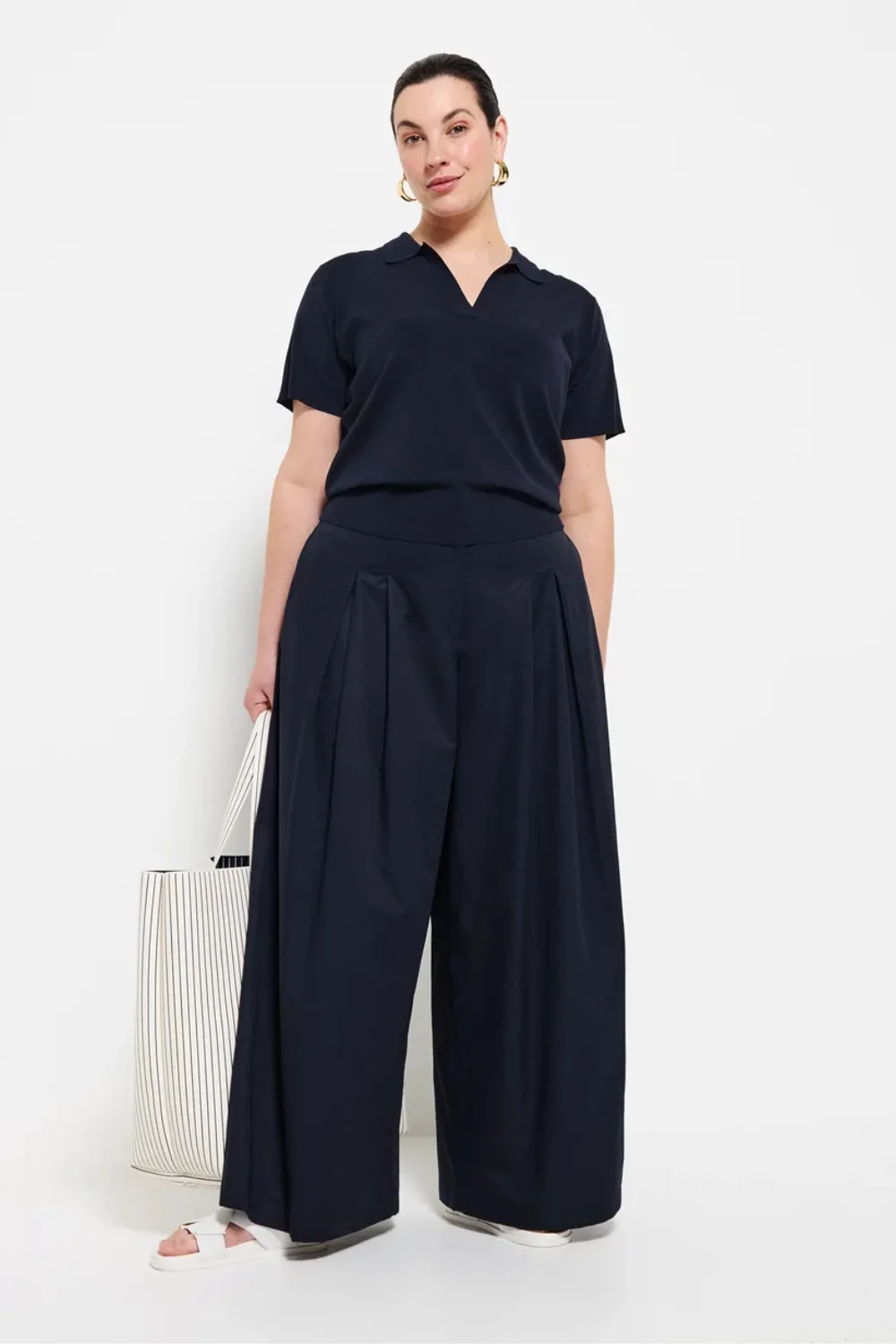 Commonry model wearing navy blue shirt and pants best plus size clothing brands