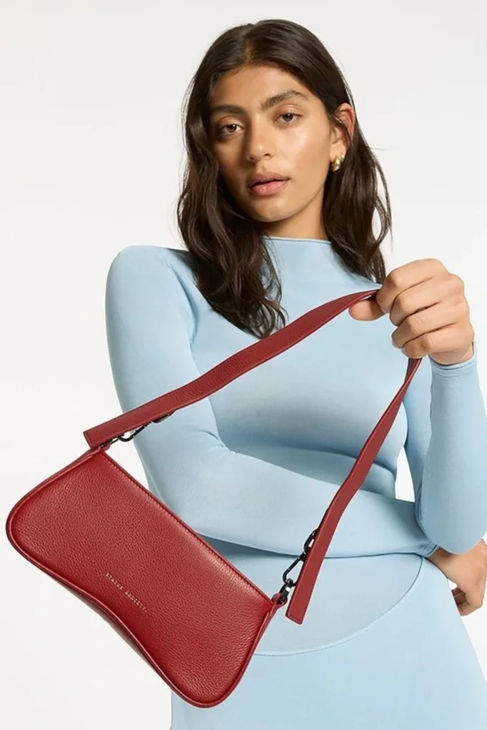 status anxiety red hand bag